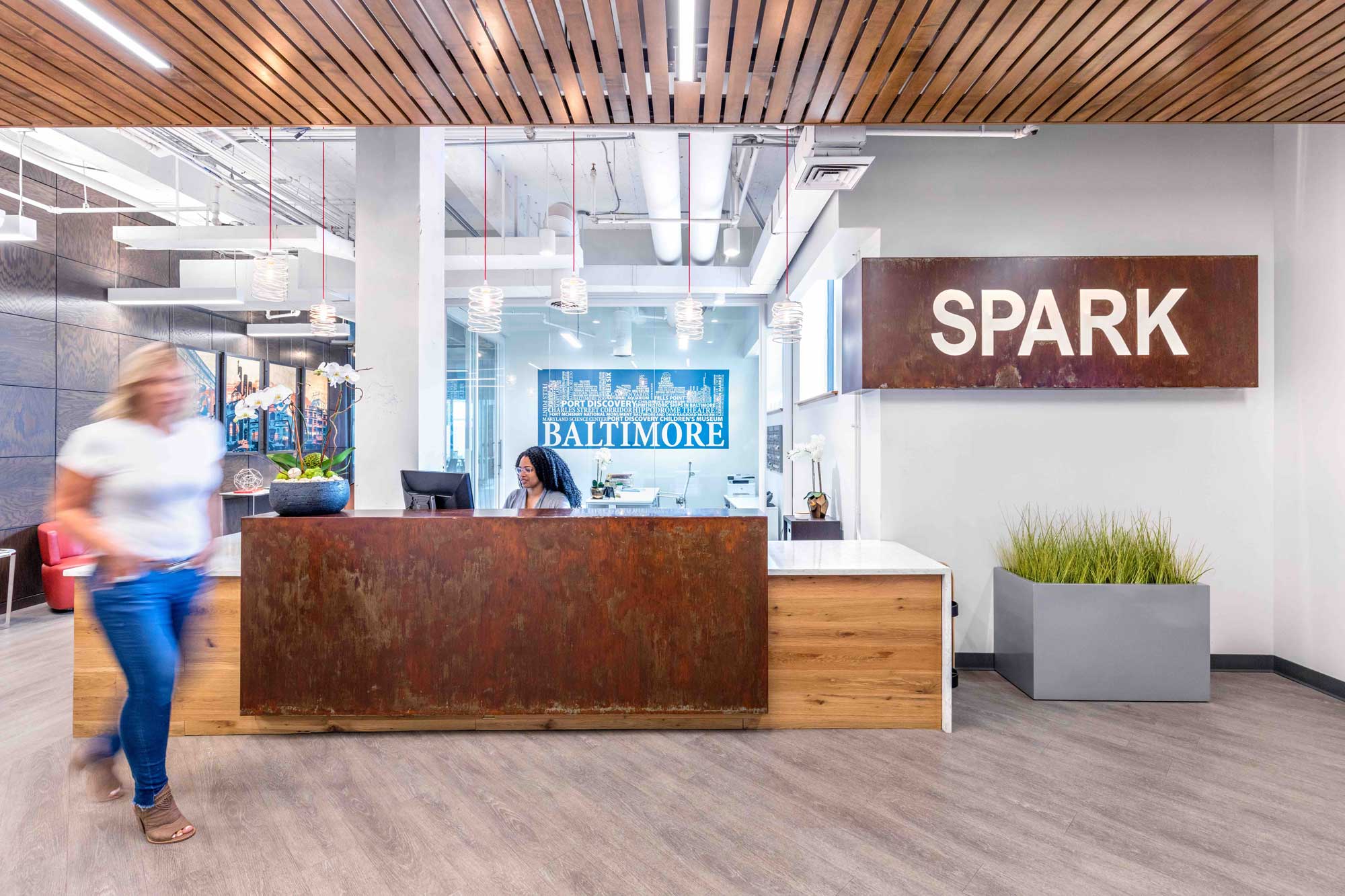 Reception desk and Spark sign at Spark Baltimore.